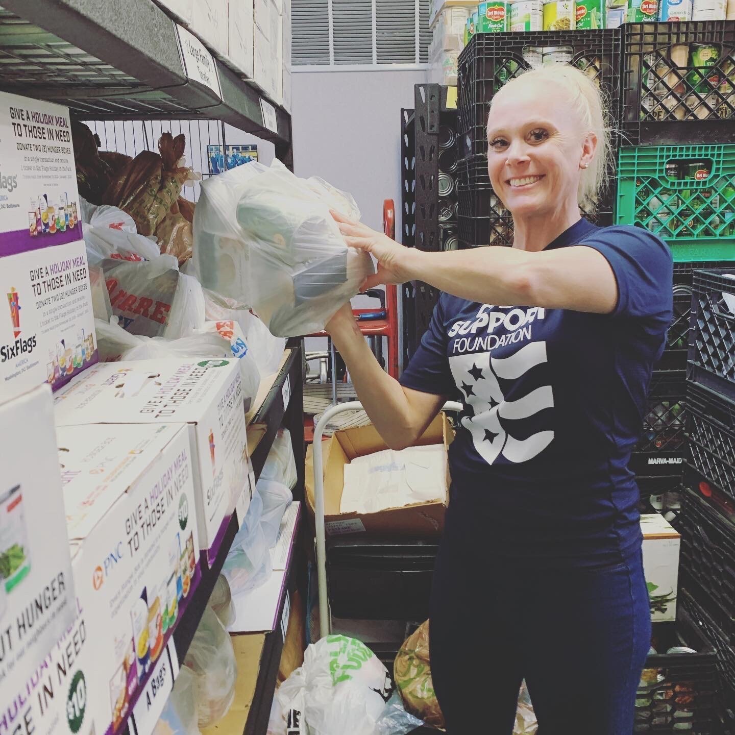 A volunteer helping to put items on shelves