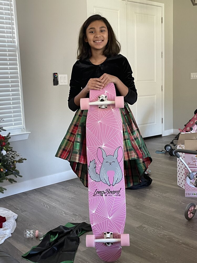 smiling girl with pink skate board