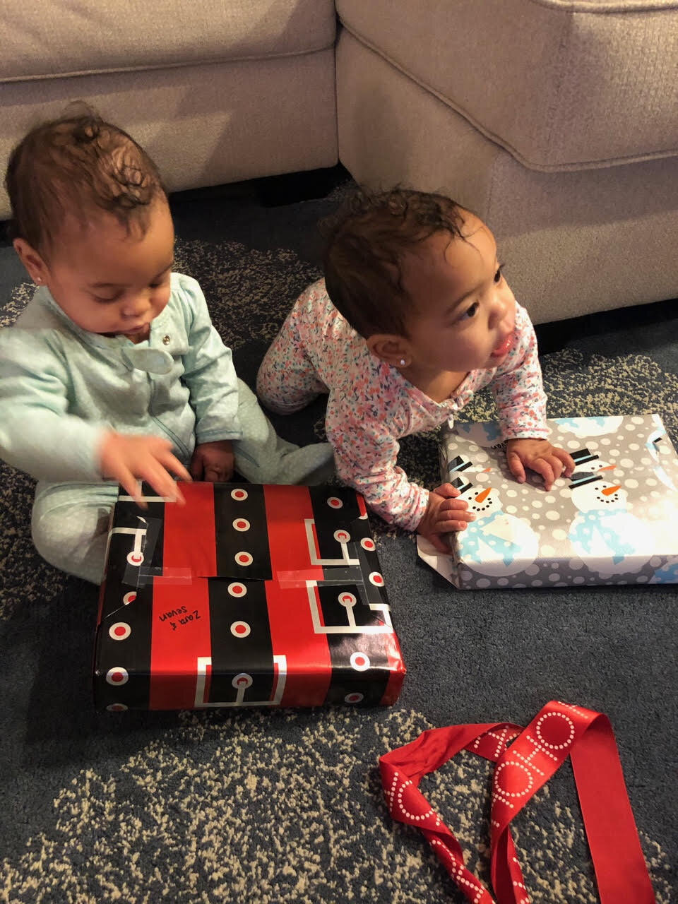 two babies with a Christmas present