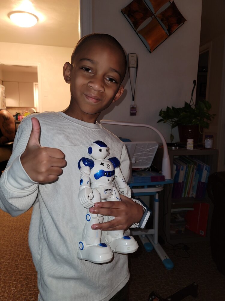 smiling boy with new robot toy