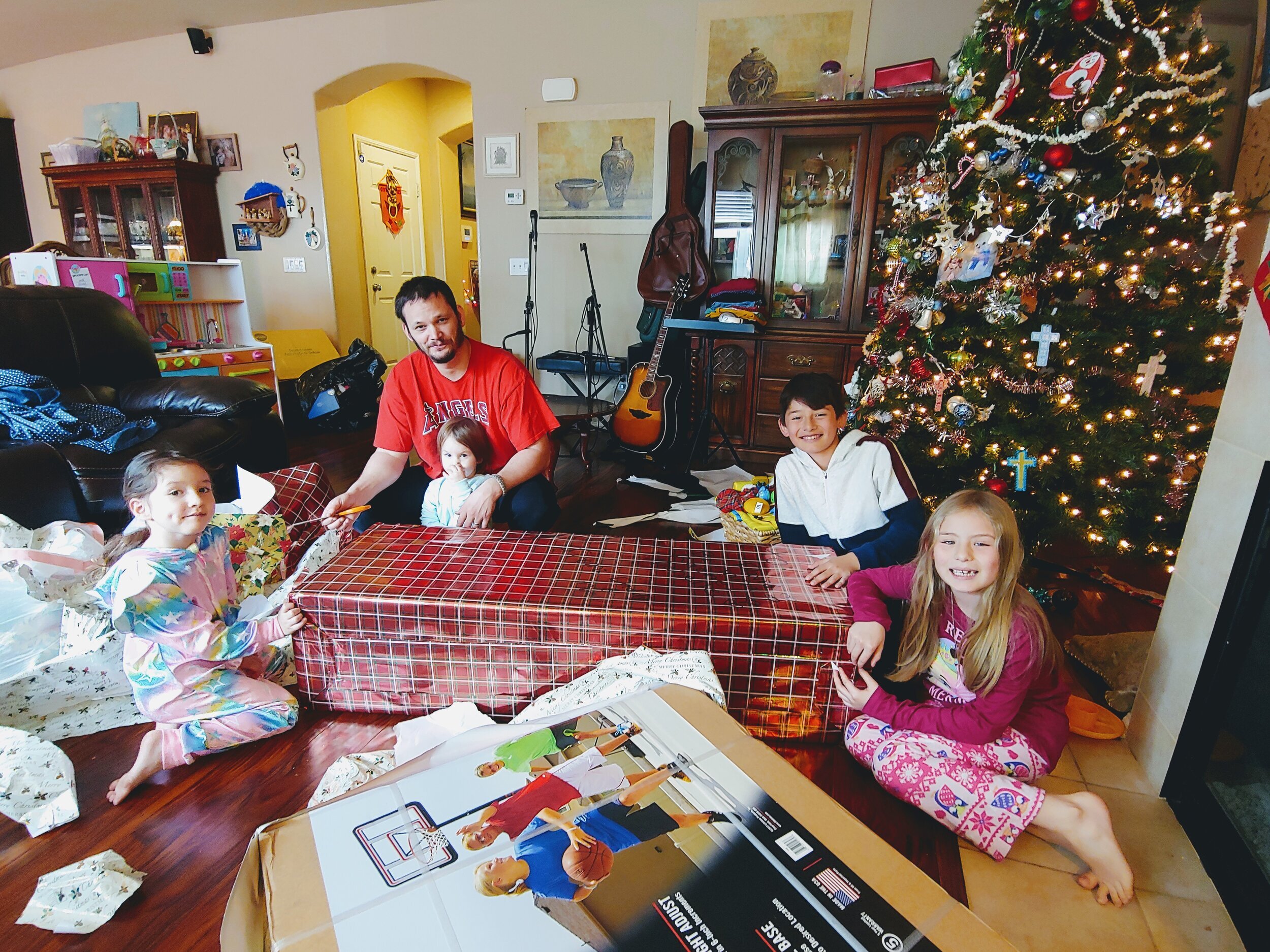 smiling family opening Christmas gifts