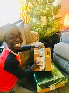 smiling boy opening a Christmas box