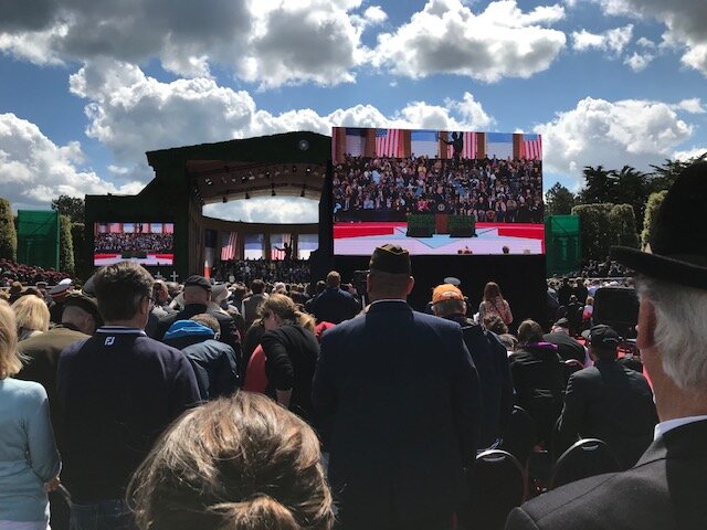 Crowd of people at a ceremony honoring the 7th anniversary of D-Day