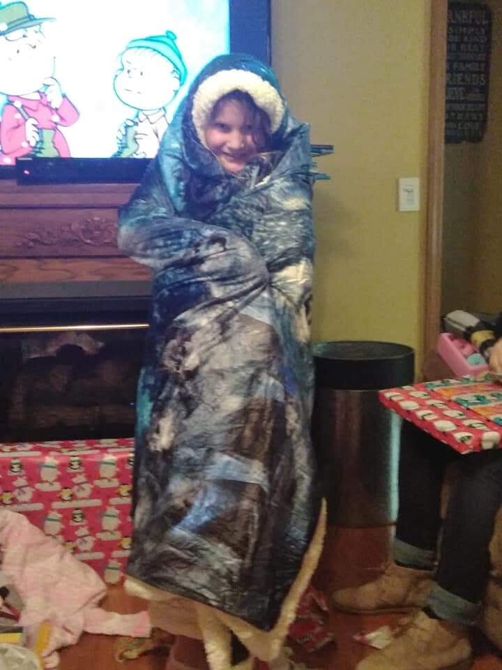 a little girl wrapped up in her new blanket