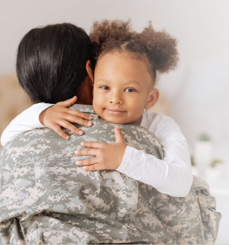 A little girl hugging her mother who is in uniform