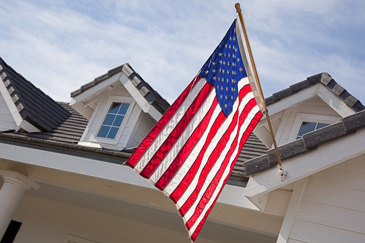 An American flag flying in front of a home