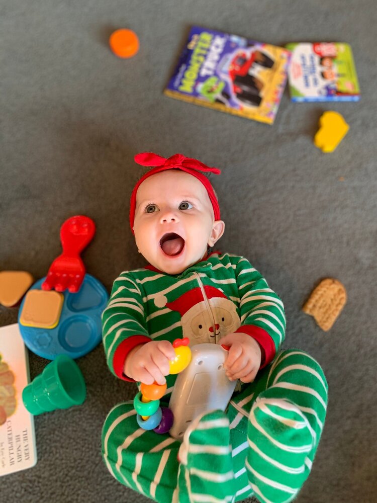 smiling baby with new toy